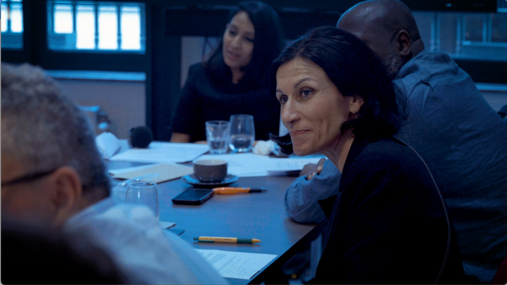 A group of people sit at a table at an encryption workshop in Brussels.