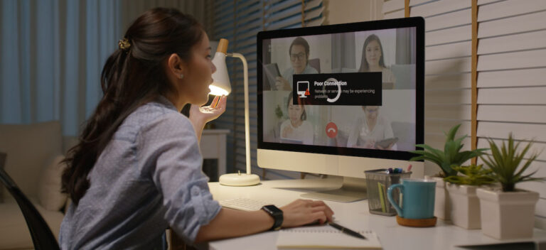 a woman looks at a computer that indicates poor connection